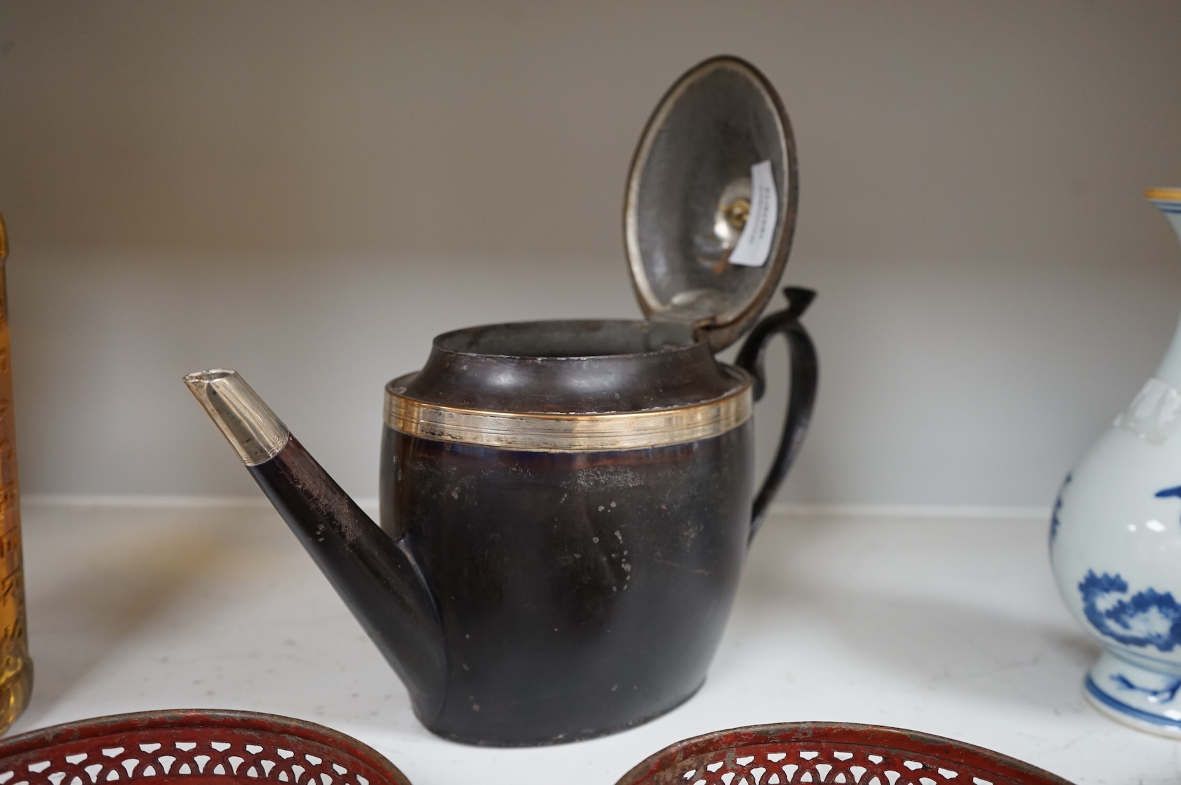 A George III silver and Old Sheffield plate mounted toleware teapot and a pair of red japanned toleware wine coasters, teapot 28cm wide (3)